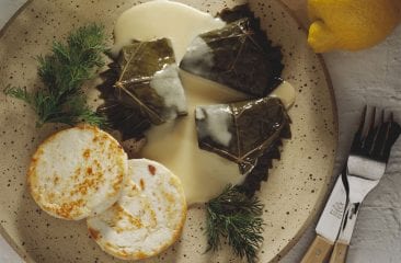 Stuffed vine leaves and cheese with lemon sauce