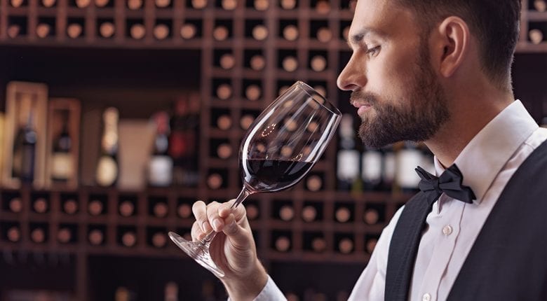 Sommelier checks aroma of wine