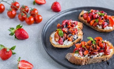 Bruschette with strawberries and cherry tomatoes in balsamic vinegar Bruschette with strawberries and cherry tomatoes in balsamic vinegar