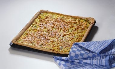 Onion and leek tart with cheese and peanuts