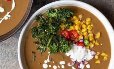 Spicy black bean soup with crispy kale, red onion and charred corn