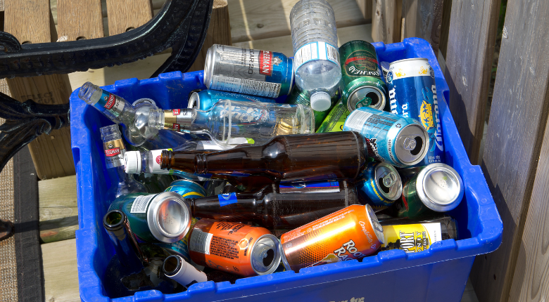 a recycling bin full of empty bottles and cans.