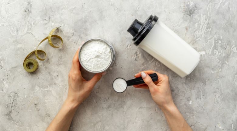 person holding a scoop of protein powder
