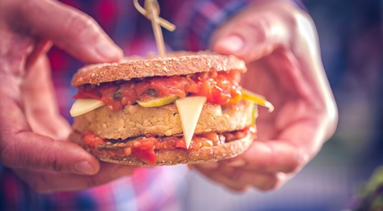 person holding a tofu burger