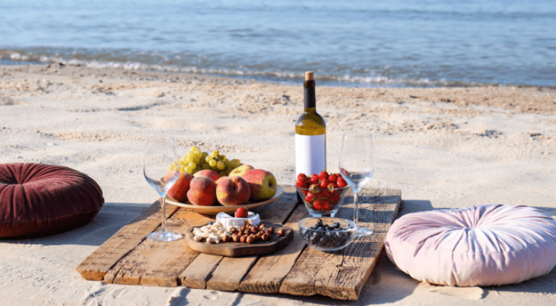 Beach picnic with fruits and wine