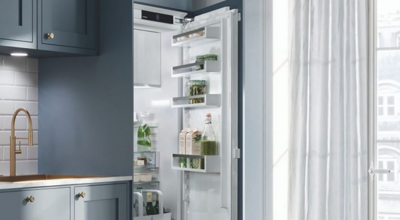 Offener Einbaukühlschrank in einer schönen blauen Küche